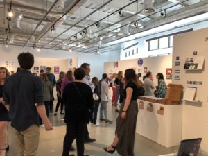 The gallery packed with people for an exhibit. 