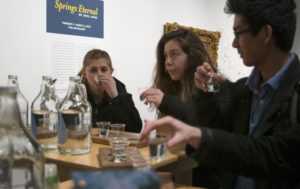 Students trying out different quality of water from a tray.